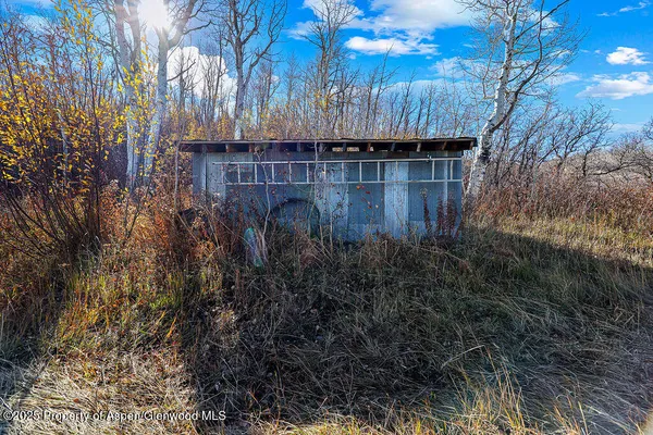 a view of backyard with tub and wooden fence