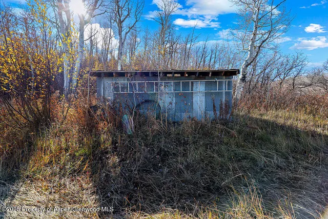 a view of backyard with tub and wooden fence