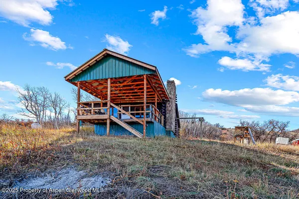 a view of a house with a yard and wooden fence