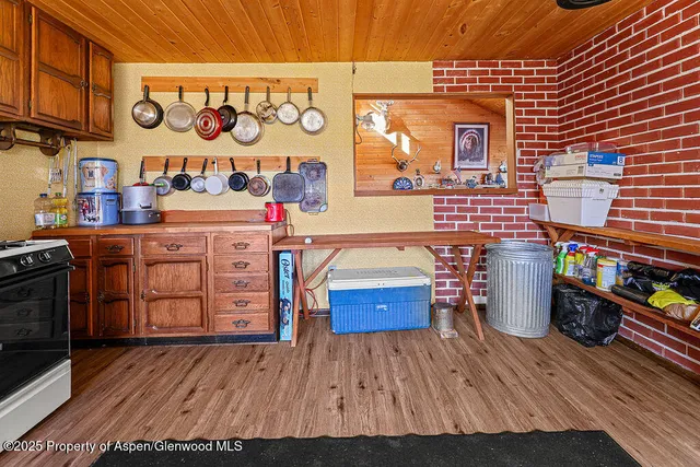 a view of a room with wooden floor