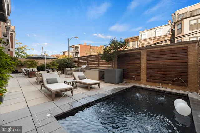 a view of a terrace with furniture and a fire pit
