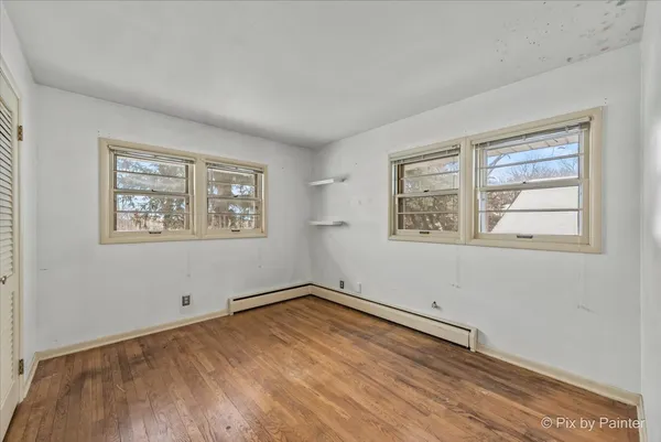 a view of a room with wooden floor and window