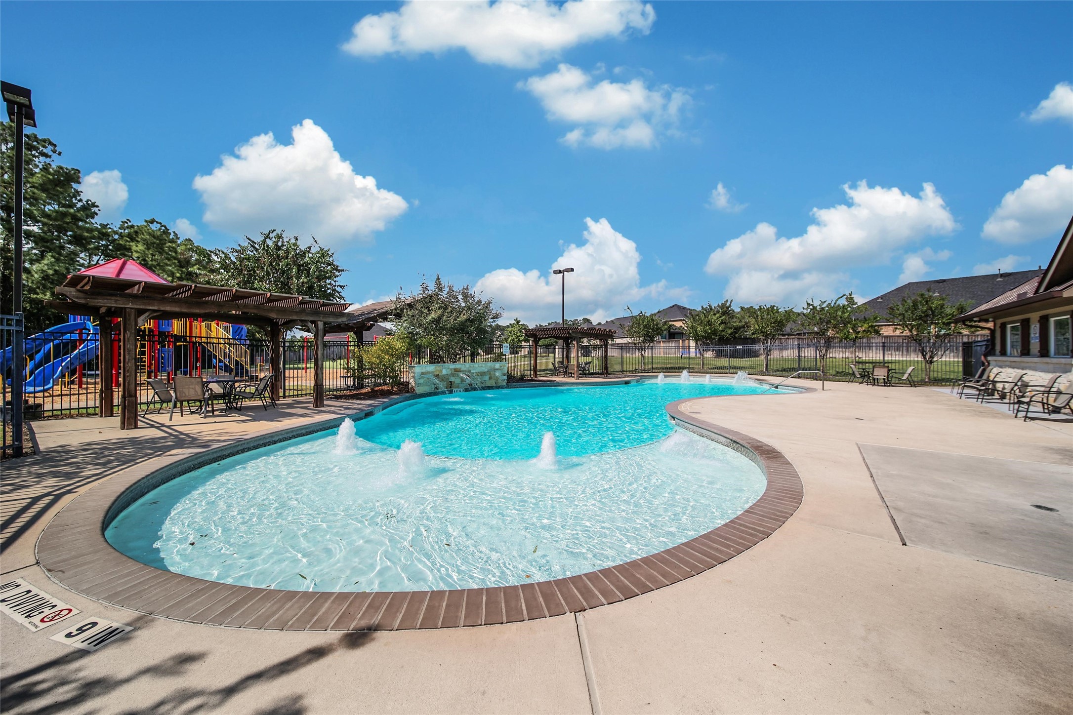 214 Pleasant Hill Way Conroe, TX 77304 - Photo 35 of 43 The large pool deck provides plenty of space for lounging by the pool.