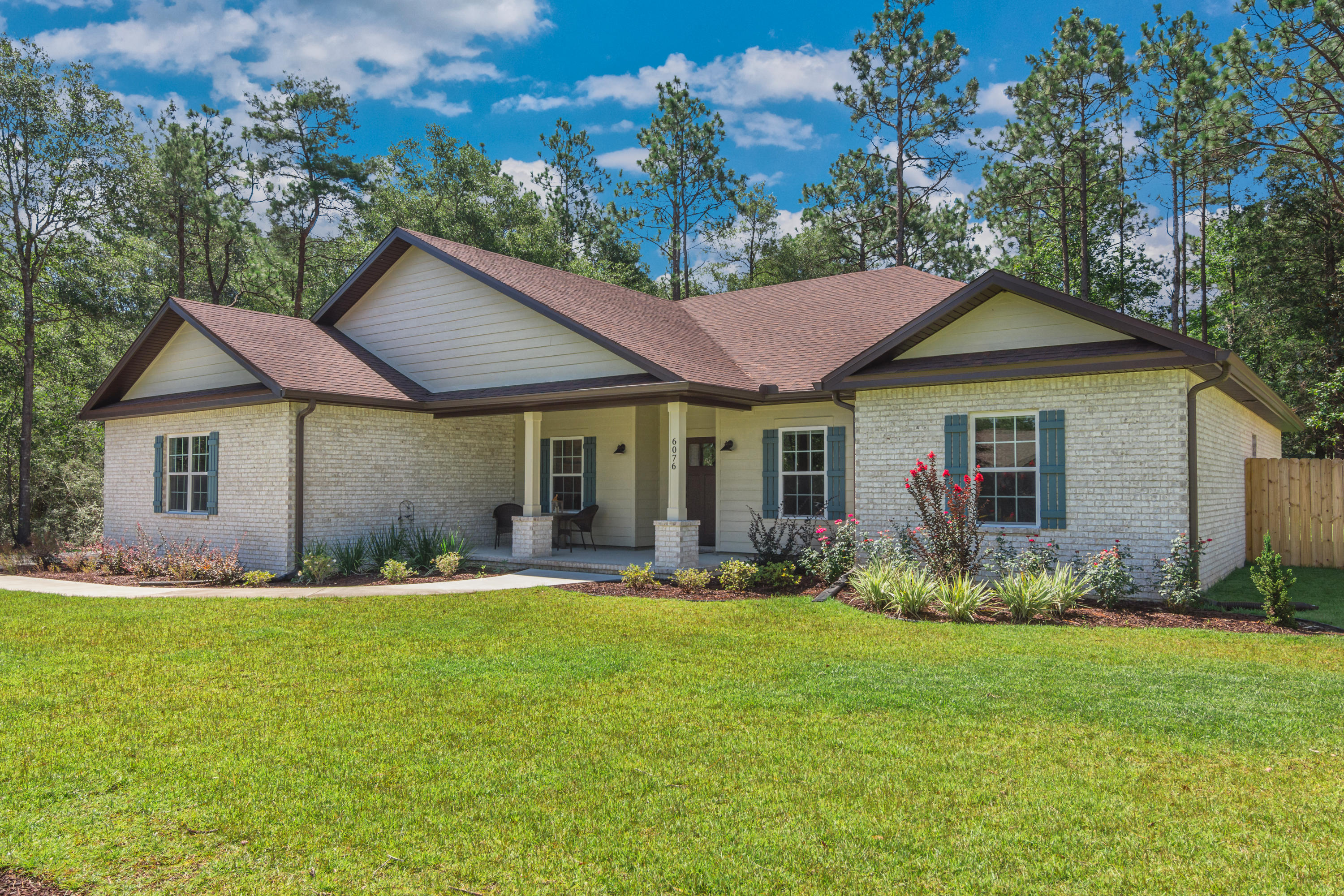 6076 Carina Road Crestview, FL 32539 - Photo 1 of 38 a front view of a house with garden