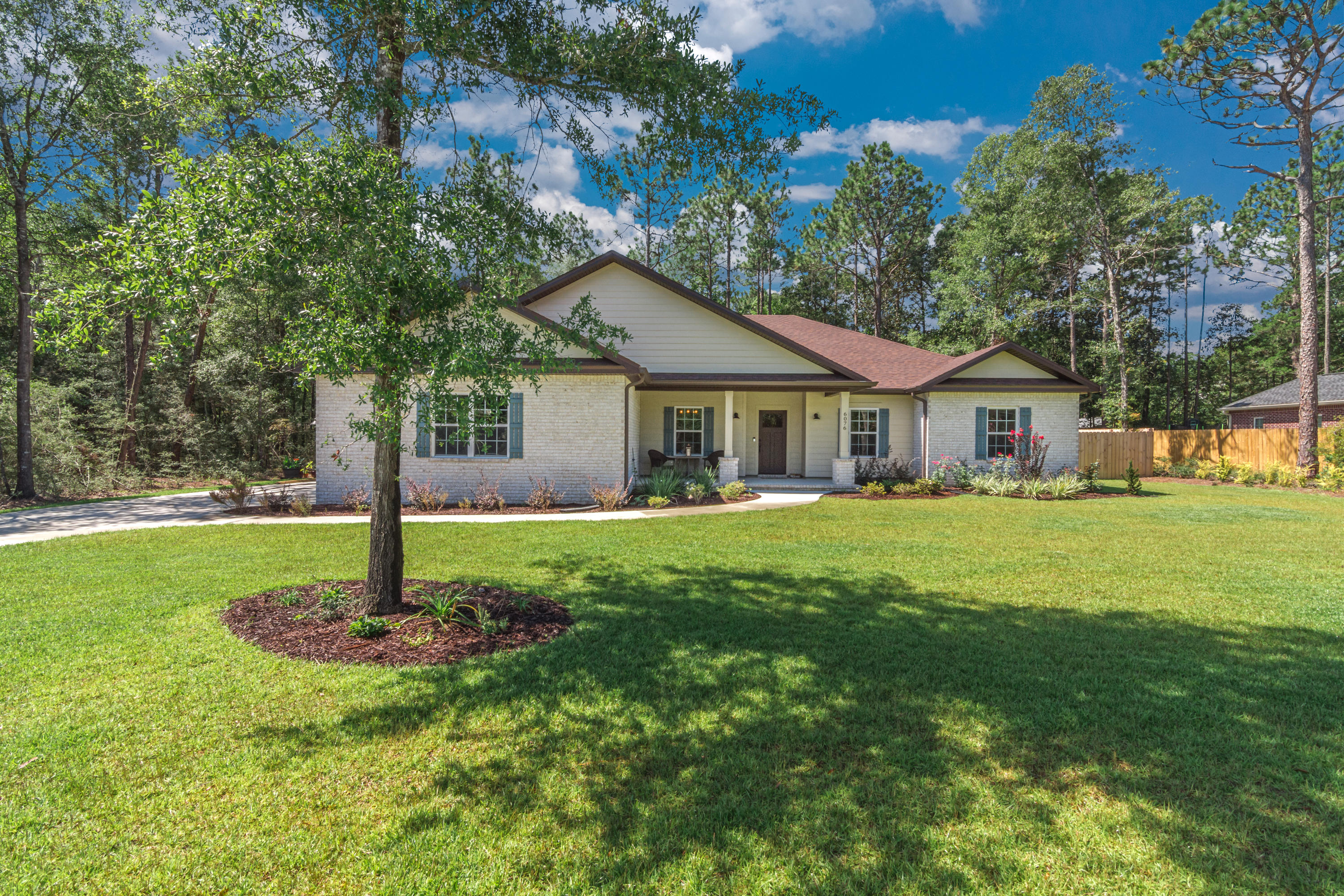 6076 Carina Road Crestview, FL 32539 - Photo 2 of 38 a front view of a house with a yard