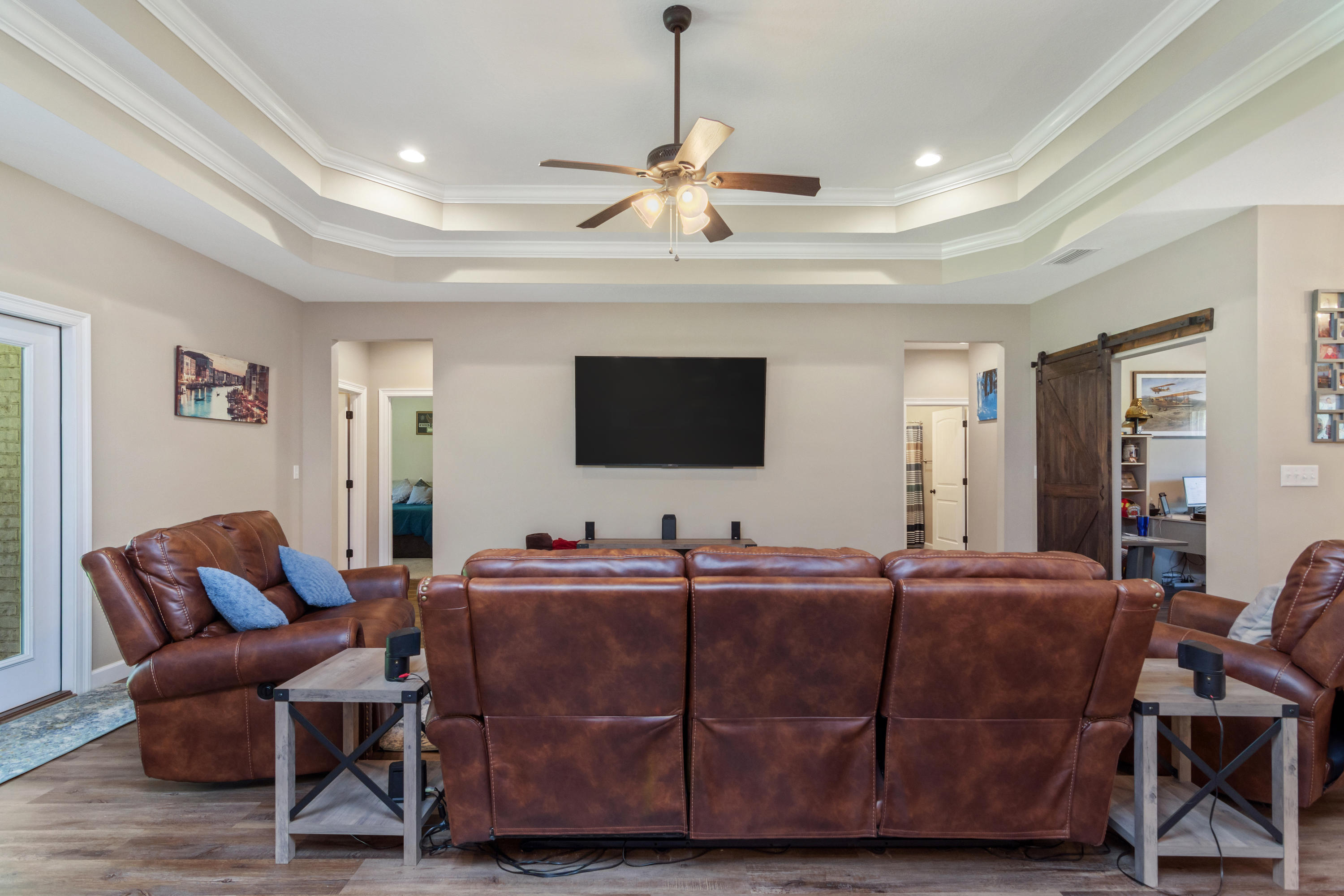 6076 Carina Road Crestview, FL 32539 - Photo 12 of 38 a living room with furniture a flat screen tv and a chandelier