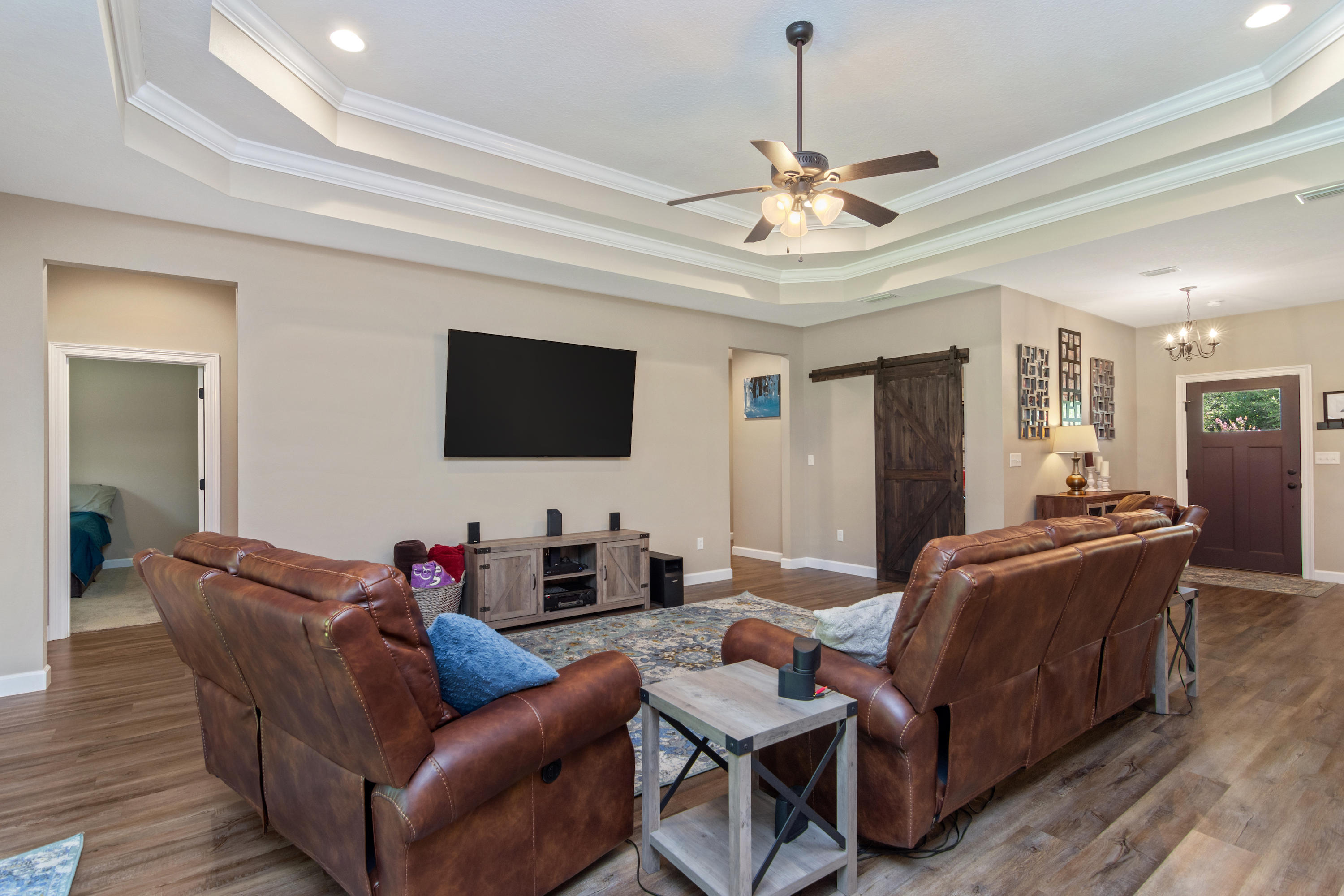 6076 Carina Road Crestview, FL 32539 - Photo 13 of 38 a living room with furniture a ceiling fan and a flat screen tv