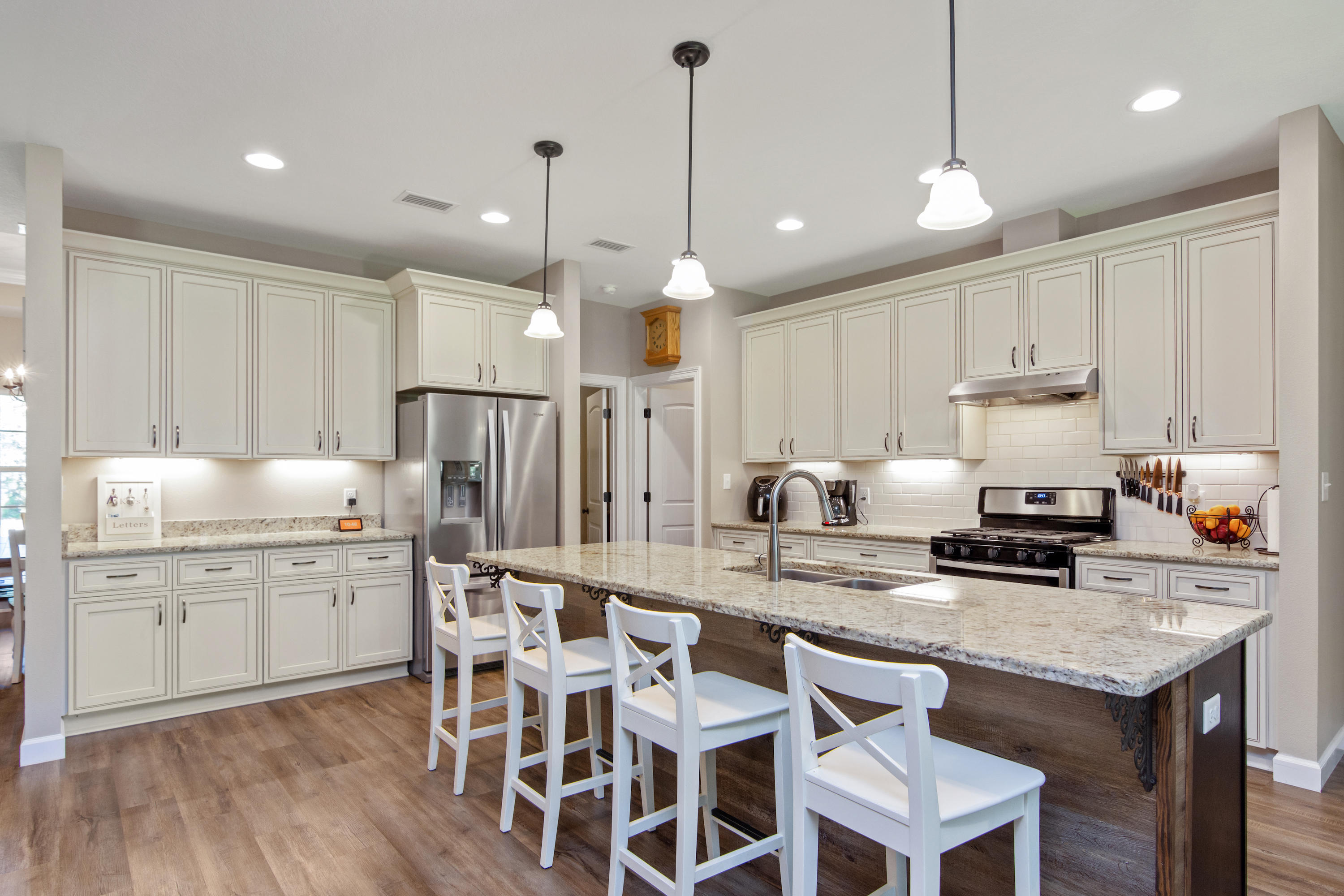 6076 Carina Road Crestview, FL 32539 - Photo 15 of 38 a kitchen with kitchen island granite countertop a sink a center island and cabinets
