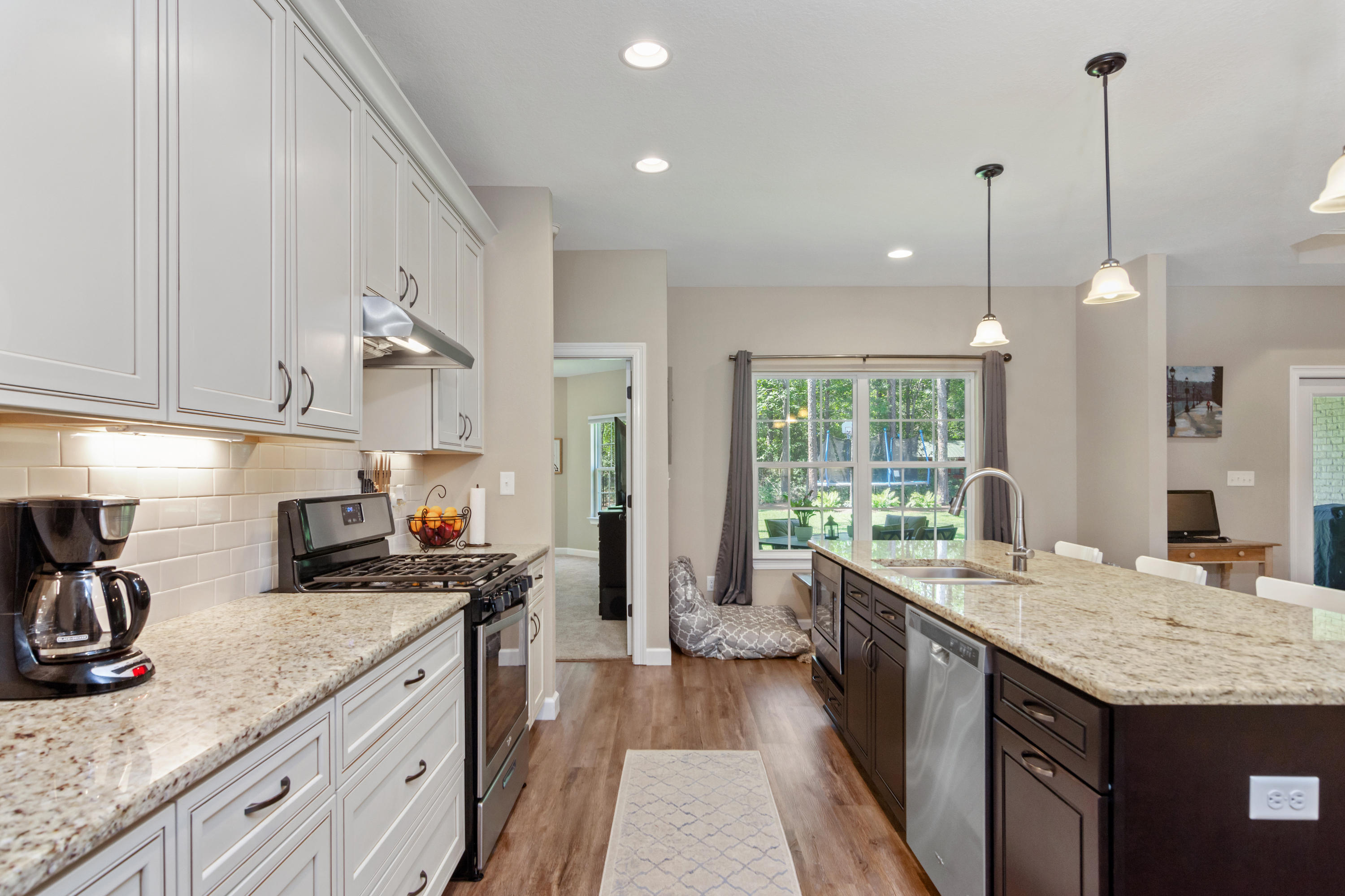 6076 Carina Road Crestview, FL 32539 - Photo 18 of 38 a kitchen with granite countertop a sink a counter space appliances and cabinets