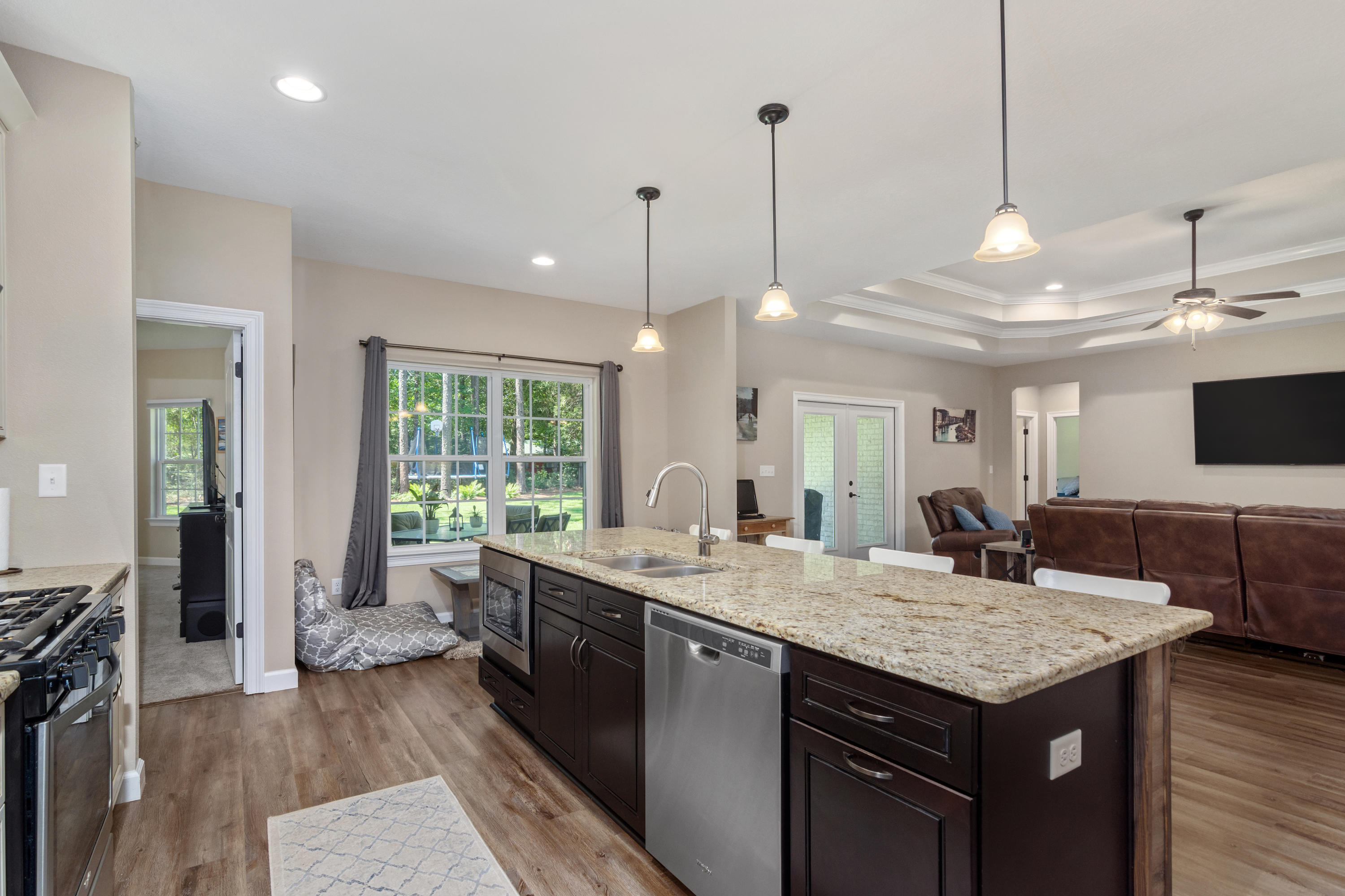6076 Carina Road Crestview, FL 32539 - Photo 19 of 38 a kitchen with a stove center island and living room view