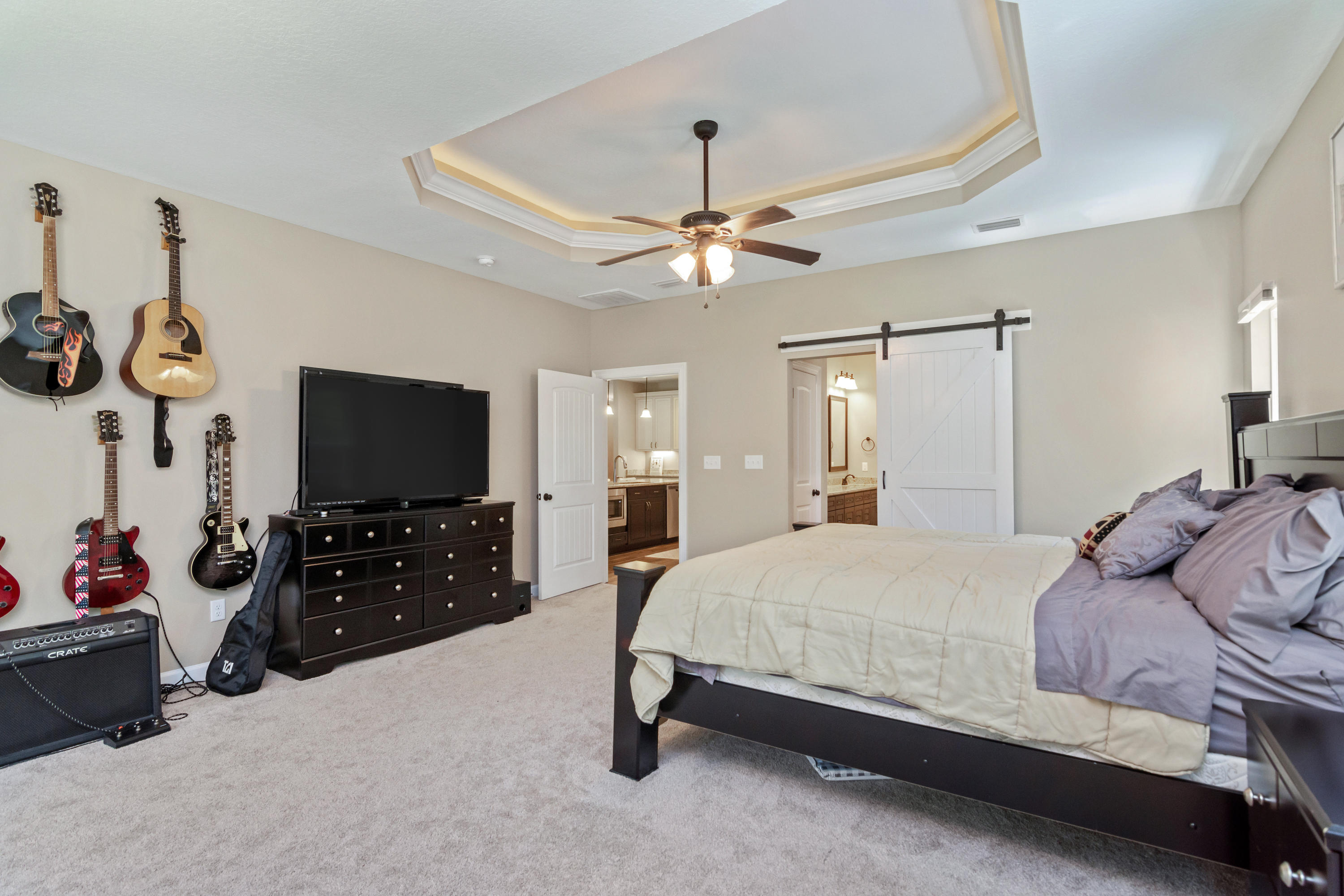 6076 Carina Road Crestview, FL 32539 - Photo 22 of 38 a bedroom with a bed and a flat tv screen on dresser