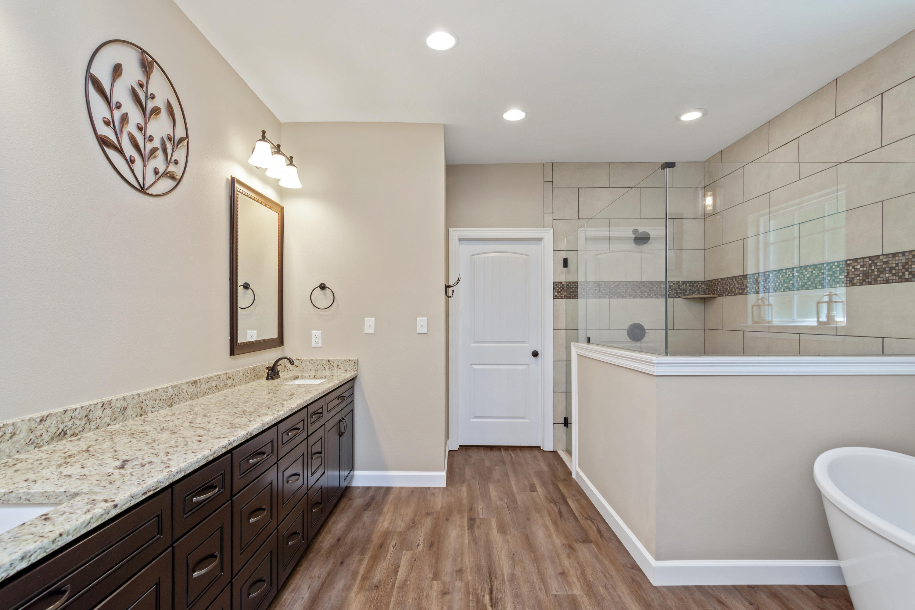 6076 Carina Road Crestview, FL 32539 - Photo 24 of 38 a spacious bathroom with a granite countertop sink a toilet a mirror and shower