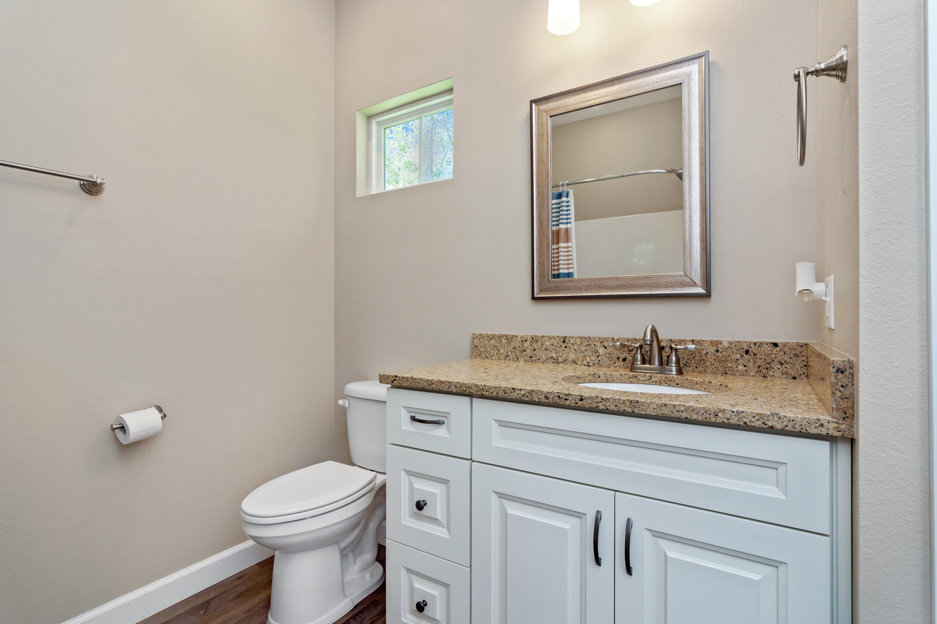 6076 Carina Road Crestview, FL 32539 - Photo 30 of 38 a bathroom with a granite countertop toilet sink and mirror