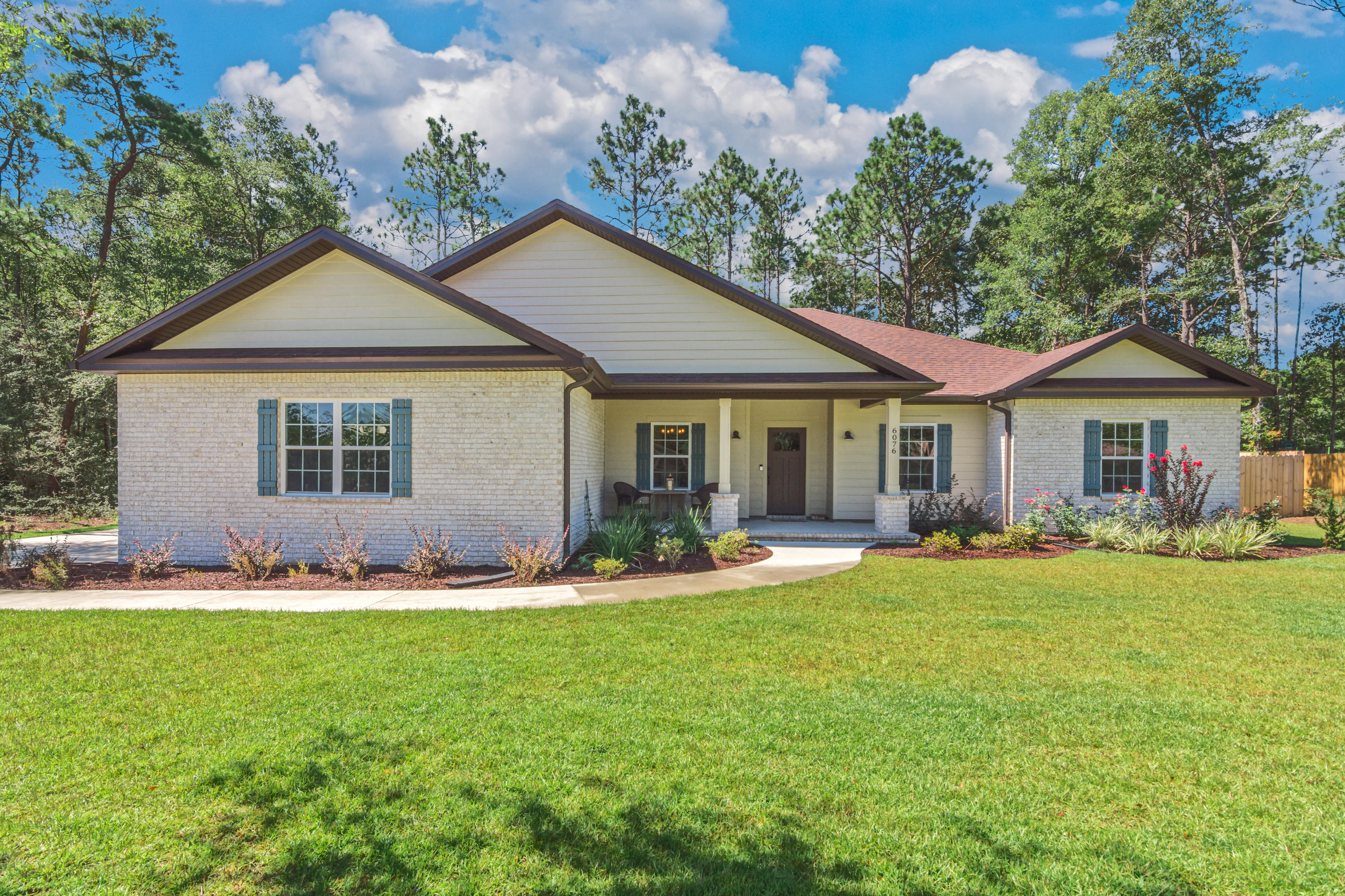 6076 Carina Road Crestview, FL 32539 - Photo 4 of 38 a front view of a house with a yard and porch
