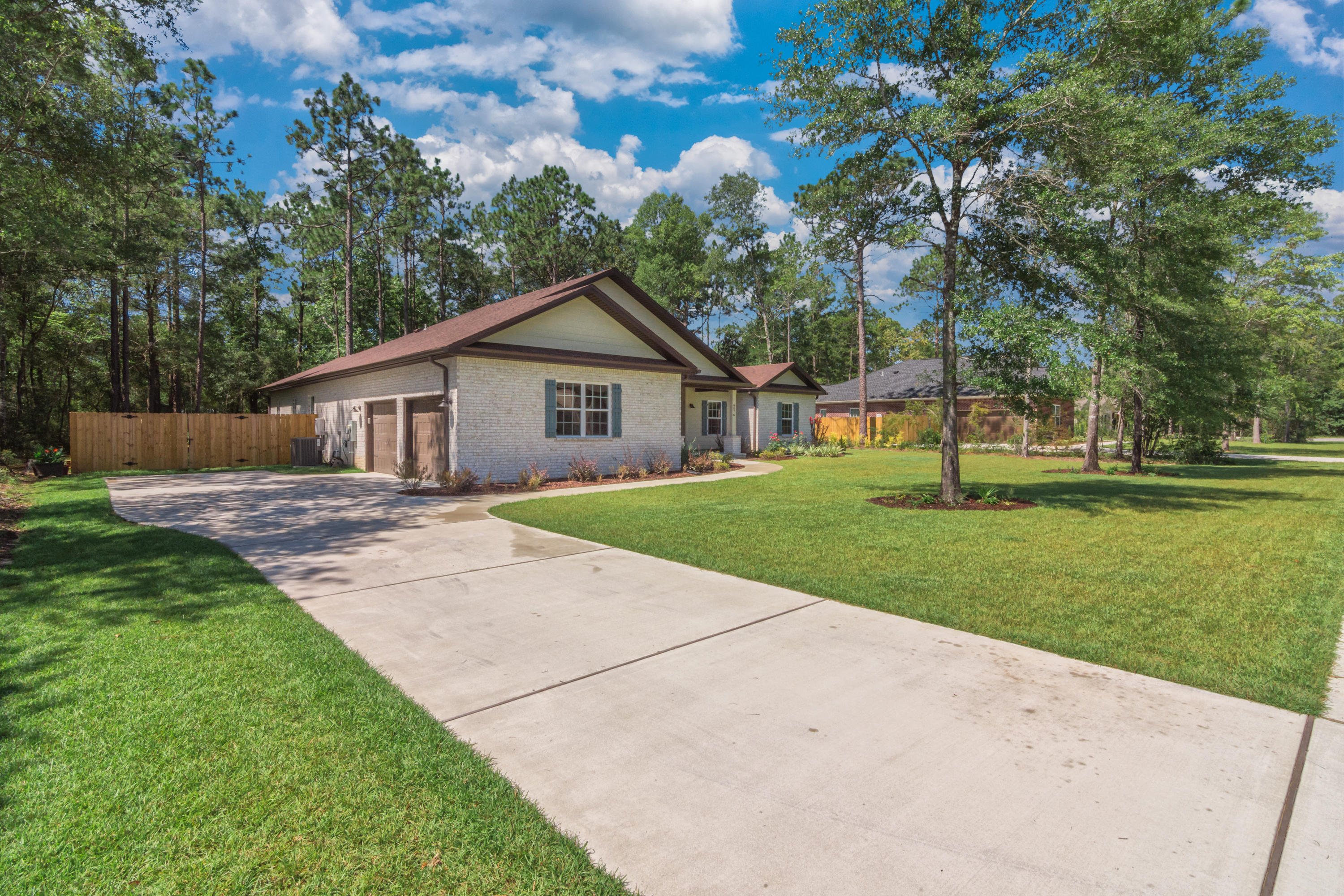 6076 Carina Road Crestview, FL 32539 - Photo 5 of 38 a view of a house with a big yard plants and large trees
