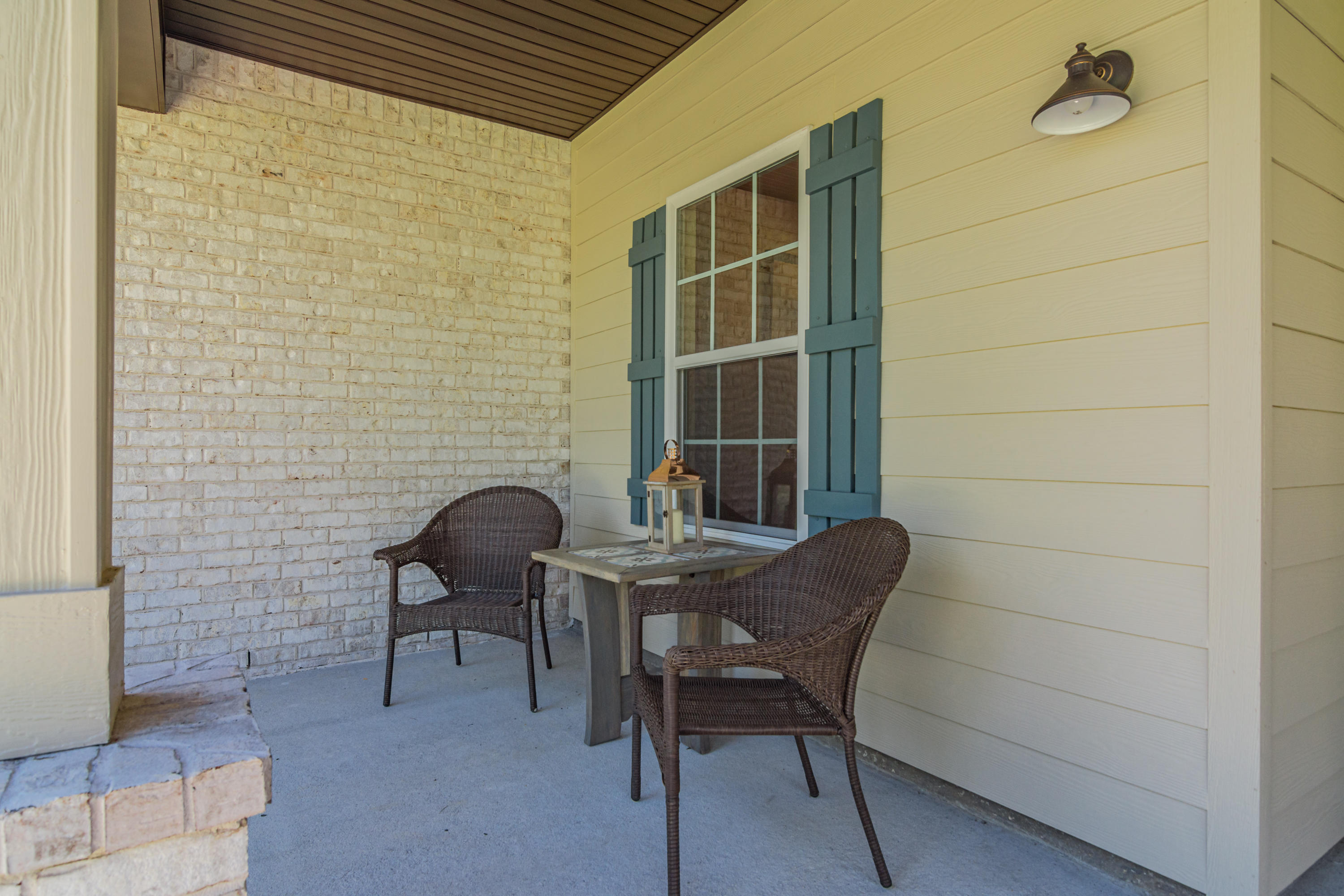 6076 Carina Road Crestview, FL 32539 - Photo 8 of 38 a patio with table and chairs and potted plants