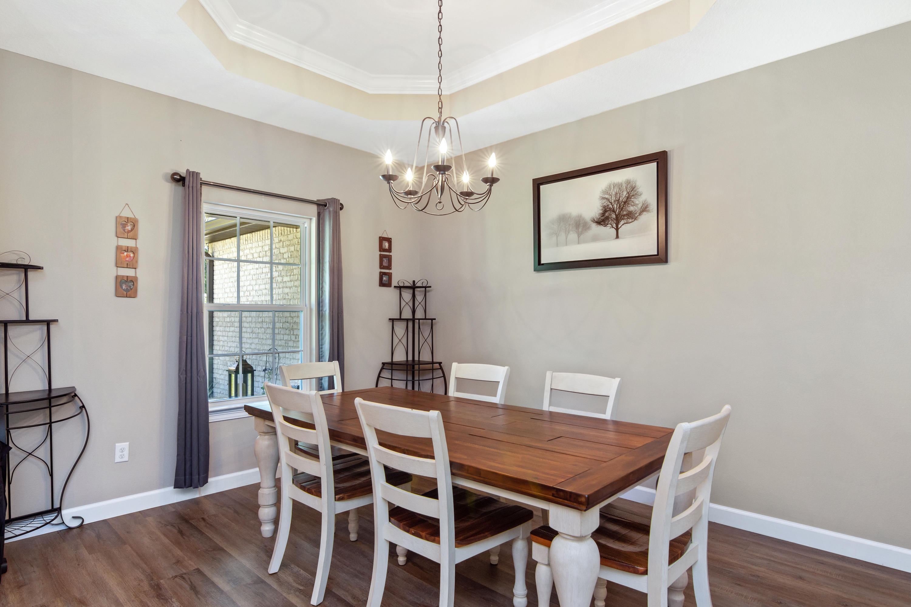 6076 Carina Road Crestview, FL 32539 - Photo 10 of 38 a view of a dining room with furniture window and wooden floor