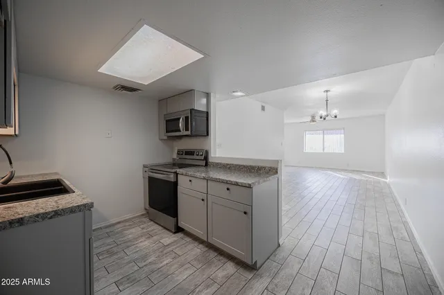 a kitchen with a sink and a stove top oven