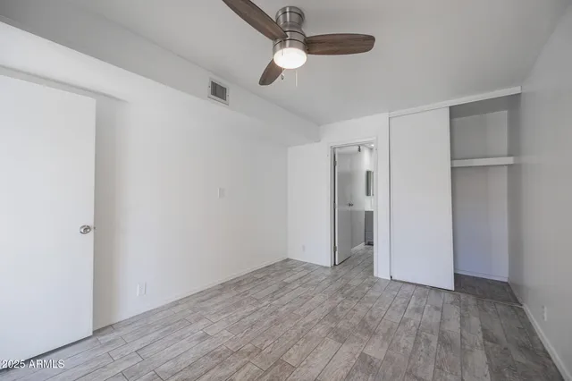 a view of an empty room with wooden floor