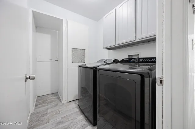 a utility room with sink dryer and washer