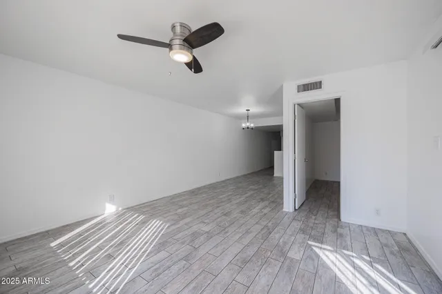 a view of a room with wooden floor and white walls