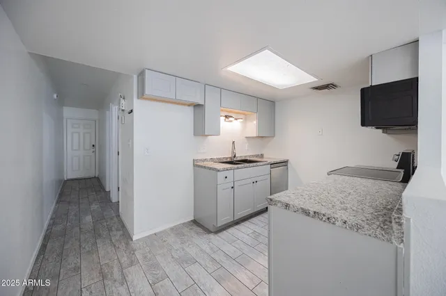 a kitchen with a sink stove and refrigerator