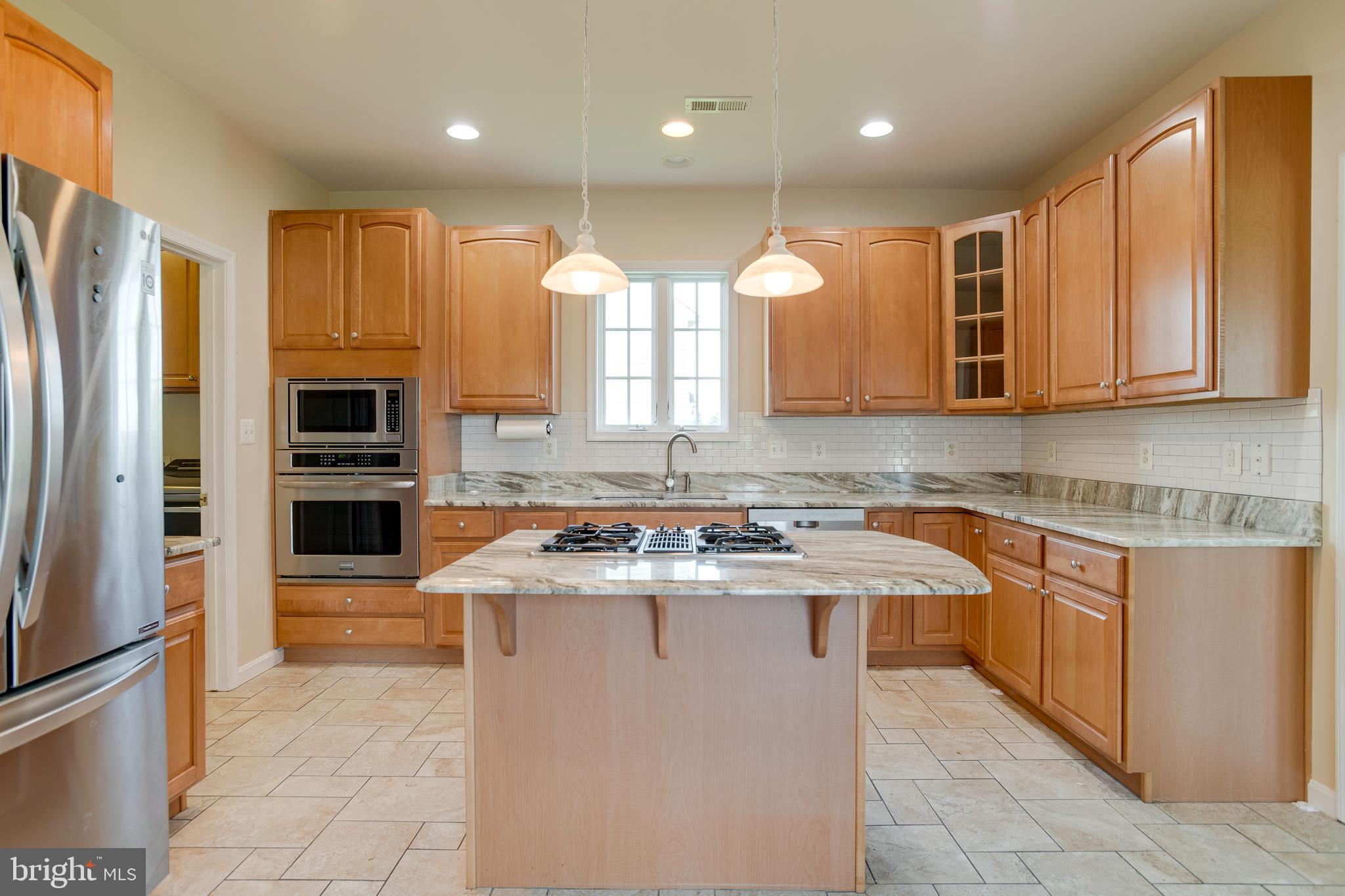 14308 South Hall Court Culpeper, VA 22701 - Photo 10 of 78 a kitchen with stainless steel appliances granite countertop a sink a stove and a refrigerator
