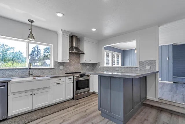 a kitchen with stainless steel appliances granite countertop a sink stove and refrigerator