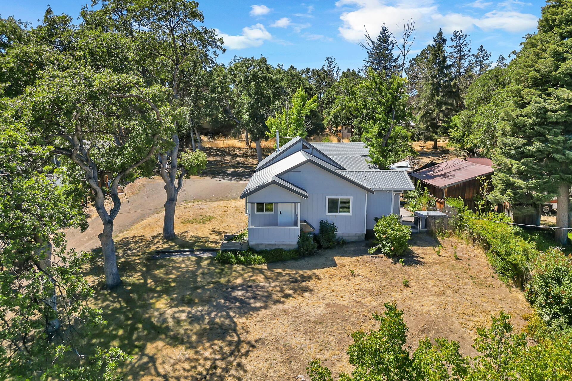 24898 Long Street Fall River Mills, CA 96028 - Photo 2 of 50 a house view with a garden space