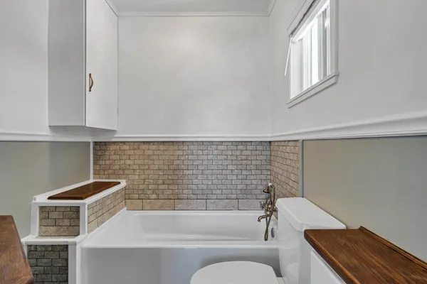 a bathroom with a sink a toilet and bathtub