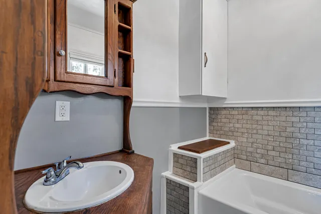 a bathroom with a sink and a mirror