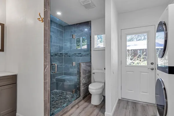 a bathroom with a toilet and a shower