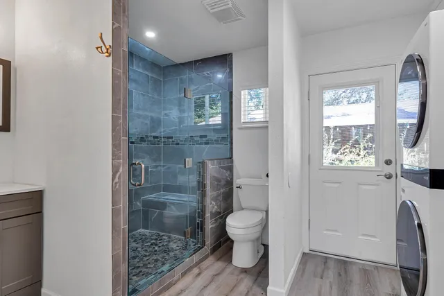 a bathroom with a toilet and a shower
