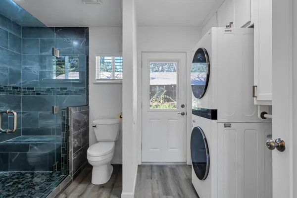 a view of a house with a tree in front of it