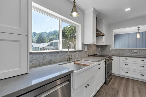 a kitchen with a sink and large window