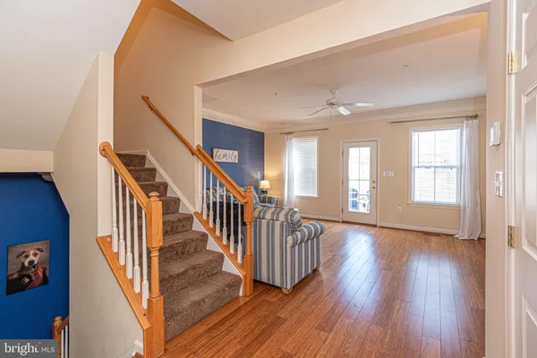 a kitchen with stainless steel appliances granite countertop a stove top oven a sink a dining table and chairs