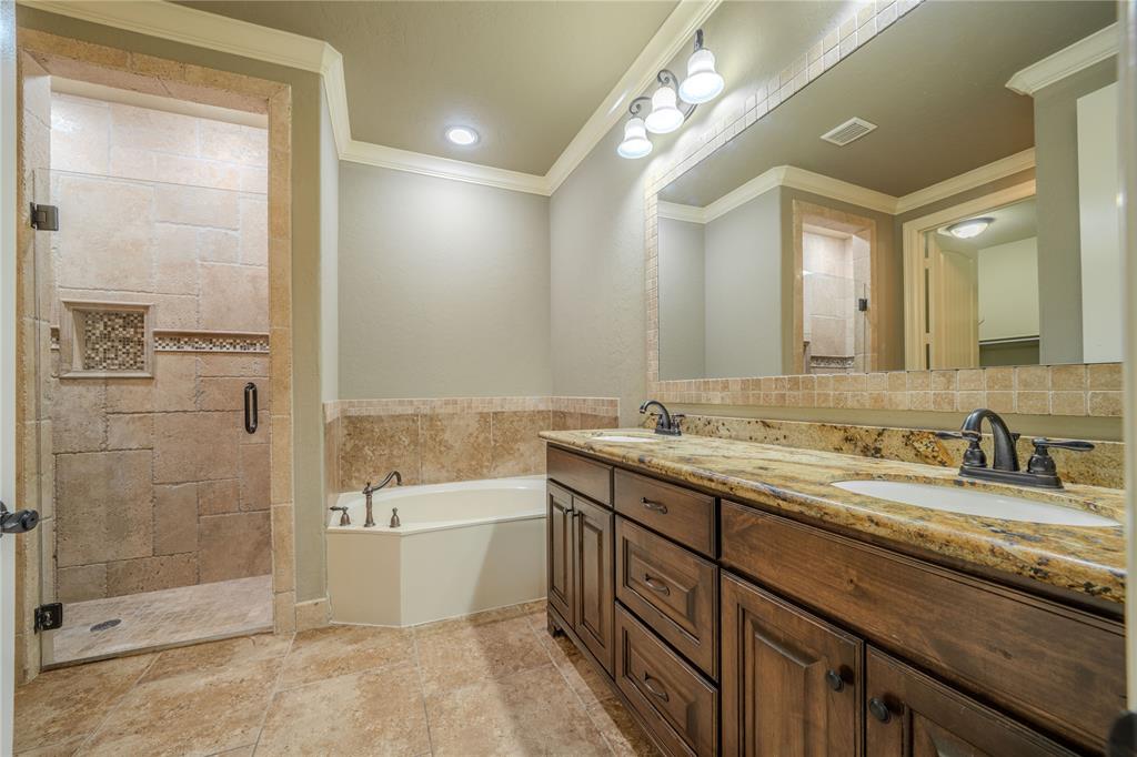 2114 West Hawkins Parkway Longview, TX 75605 - Photo 12 of 27 a bathroom with a granite countertop sink mirror and shower
