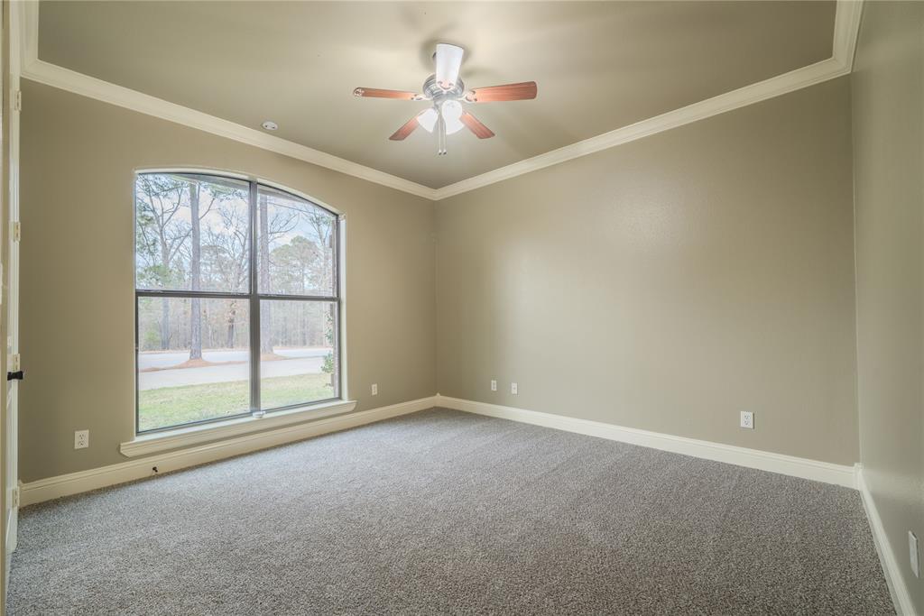 2114 West Hawkins Parkway Longview, TX 75605 - Photo 14 of 27 an empty room with chandelier fan and windows