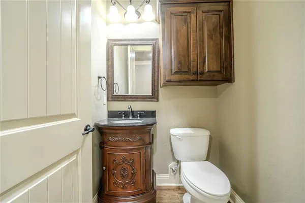 a bathroom with a toilet a sink and mirror