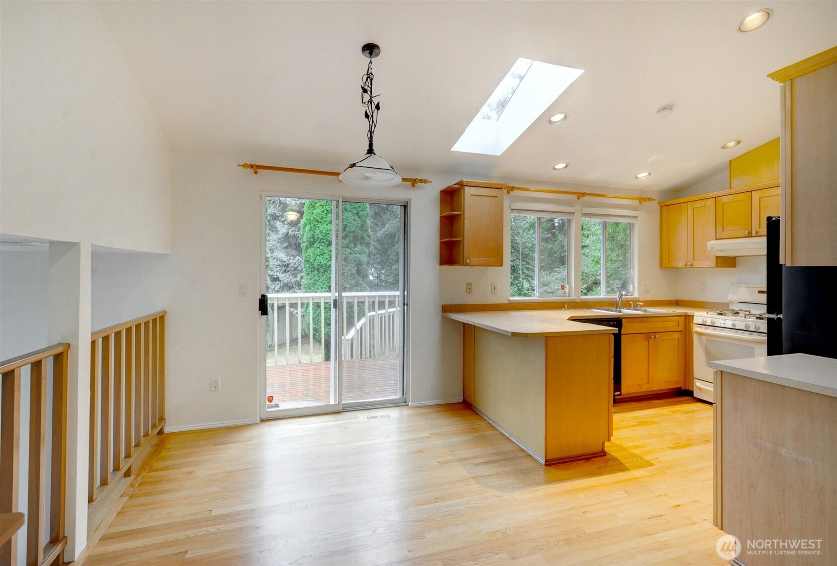 532 198th Street Southeast Bothell, WA 98012 - Photo 4 of 22 a large kitchen with stainless steel appliances granite countertop a large window and a wooden floor