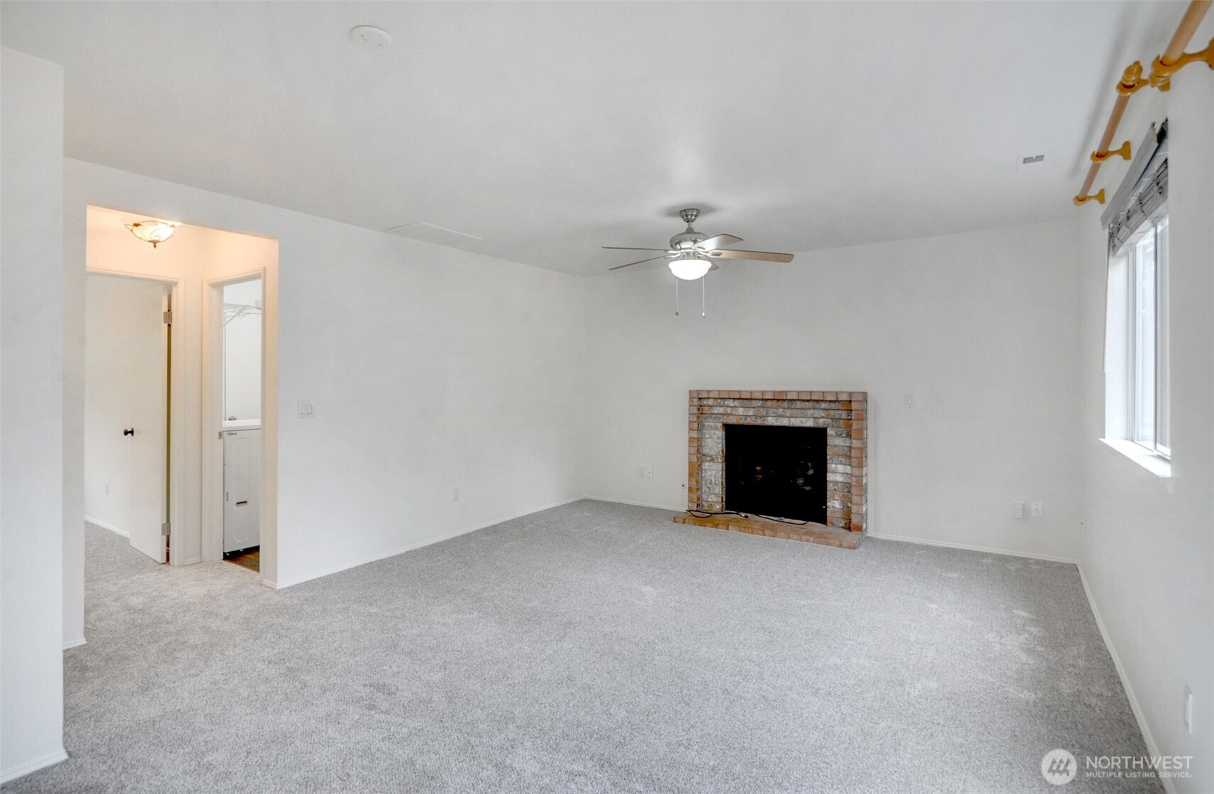 532 198th Street Southeast Bothell, WA 98012 - Photo 10 of 22 an empty room with windows and fireplace