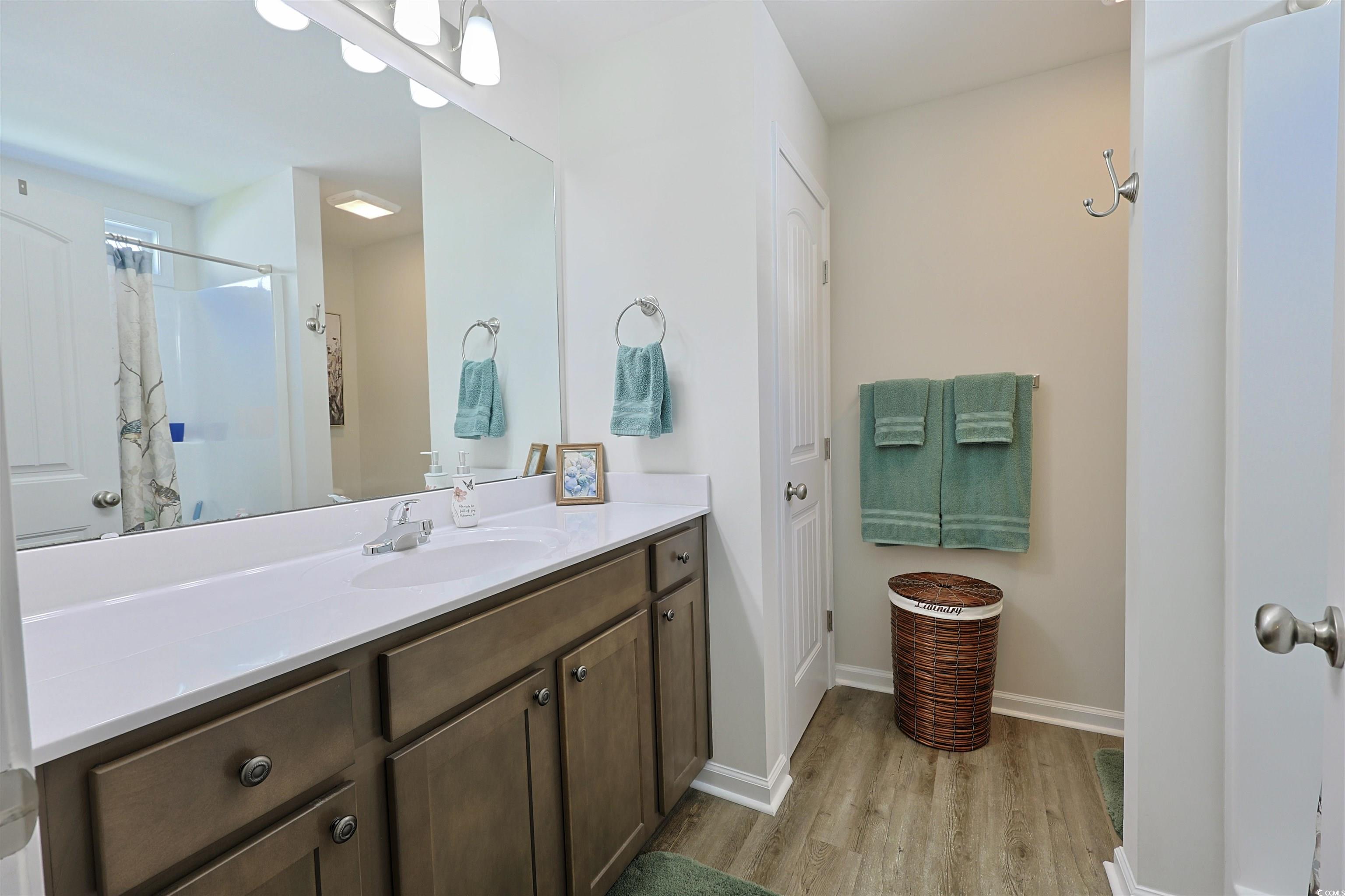 3604 Church Street Loris, SC 29569 - Photo 12 of 34 Full bathroom with vanity, wood finished floors, and a shower with shower curtain