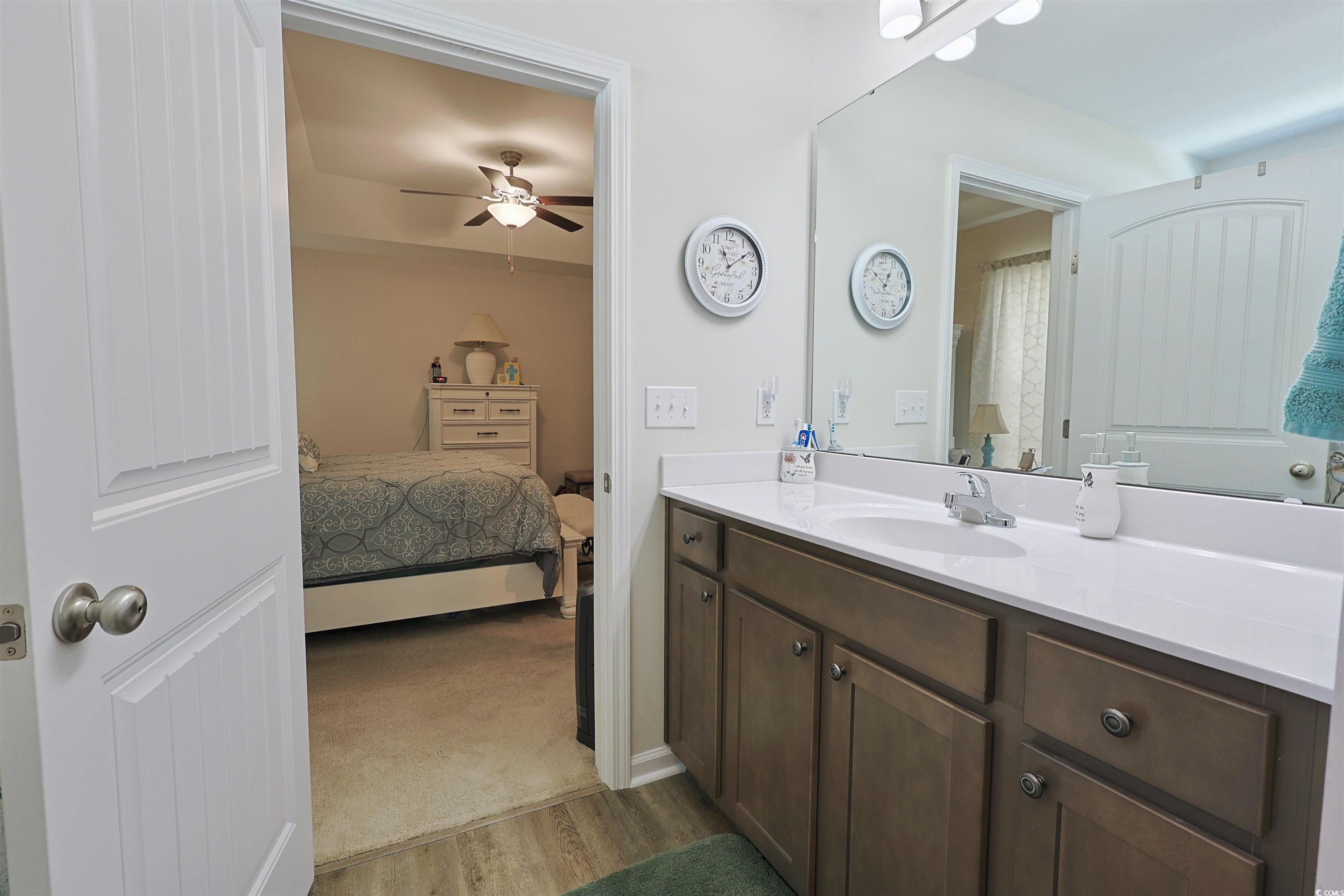 3604 Church Street Loris, SC 29569 - Photo 13 of 34 Full bath featuring vanity, ceiling fan, ensuite bathroom, and wood finished floors