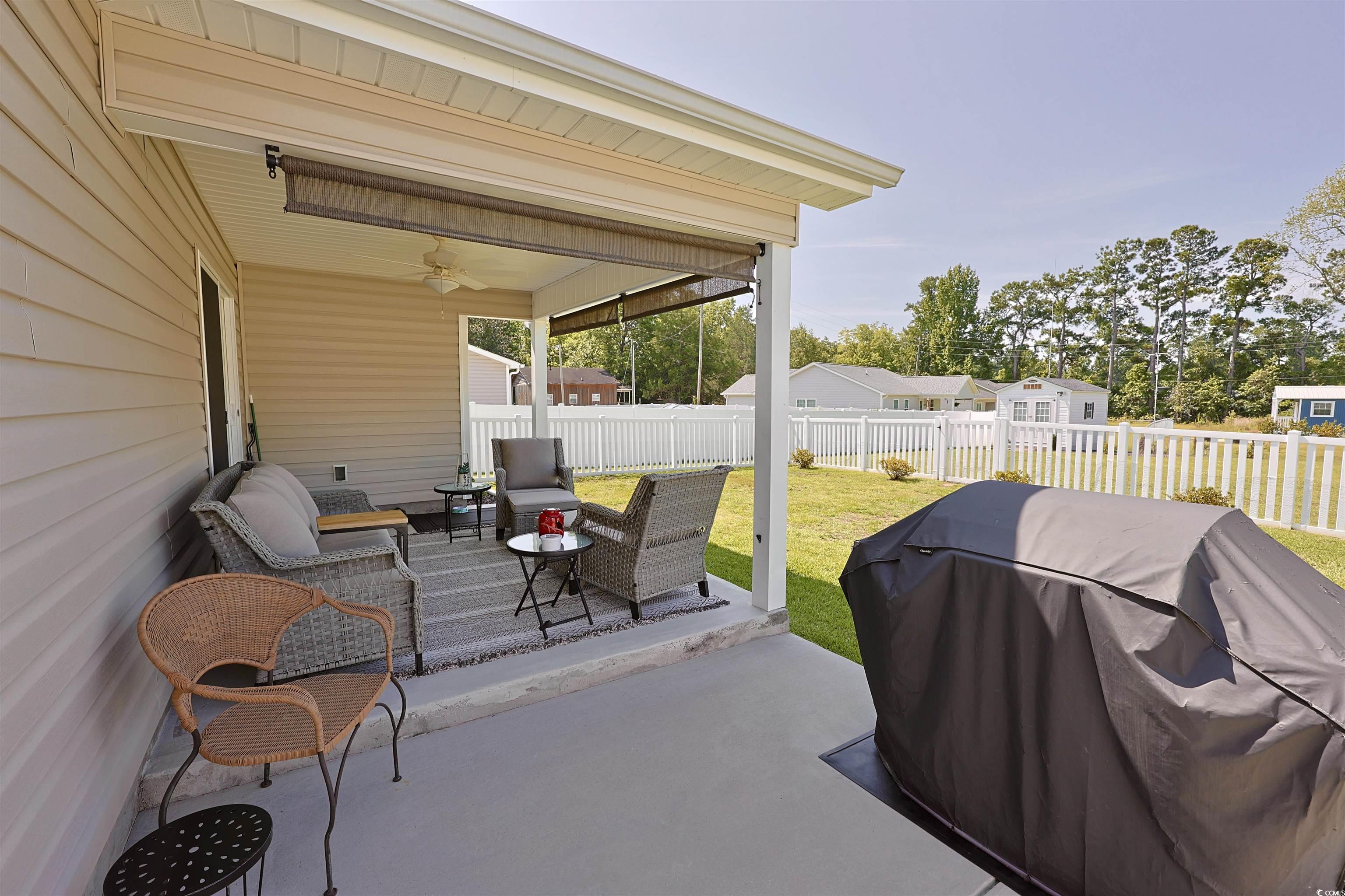 3604 Church Street Loris, SC 29569 - Photo 26 of 34 Fenced backyard featuring area for grilling, ceiling fan, a patio area, and an outdoor hangout area