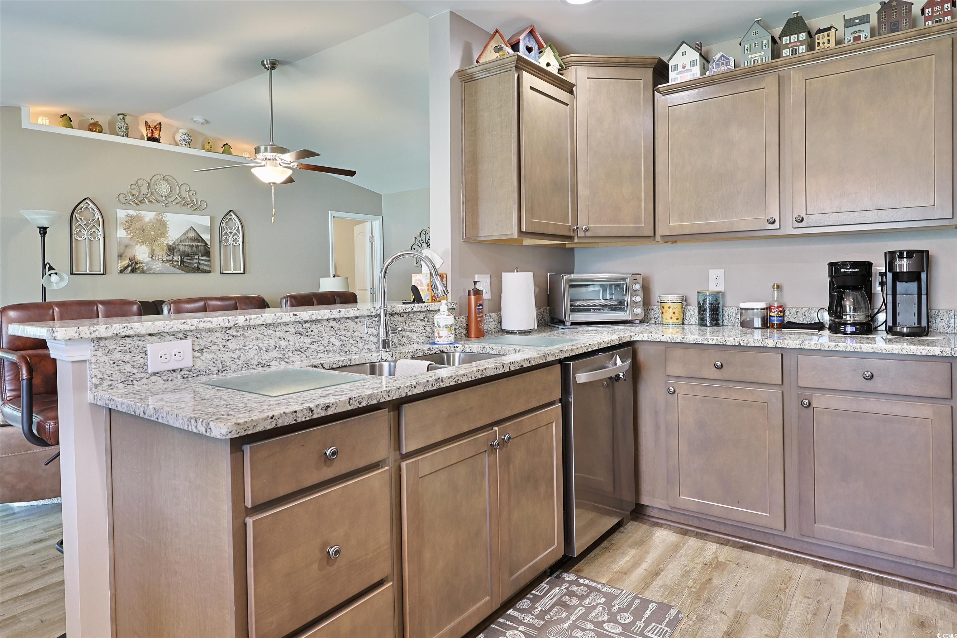 3604 Church Street Loris, SC 29569 - Photo 34 of 34 Kitchen with lofted ceiling, a ceiling fan, a peninsula, light wood finished floors, and open floor plan