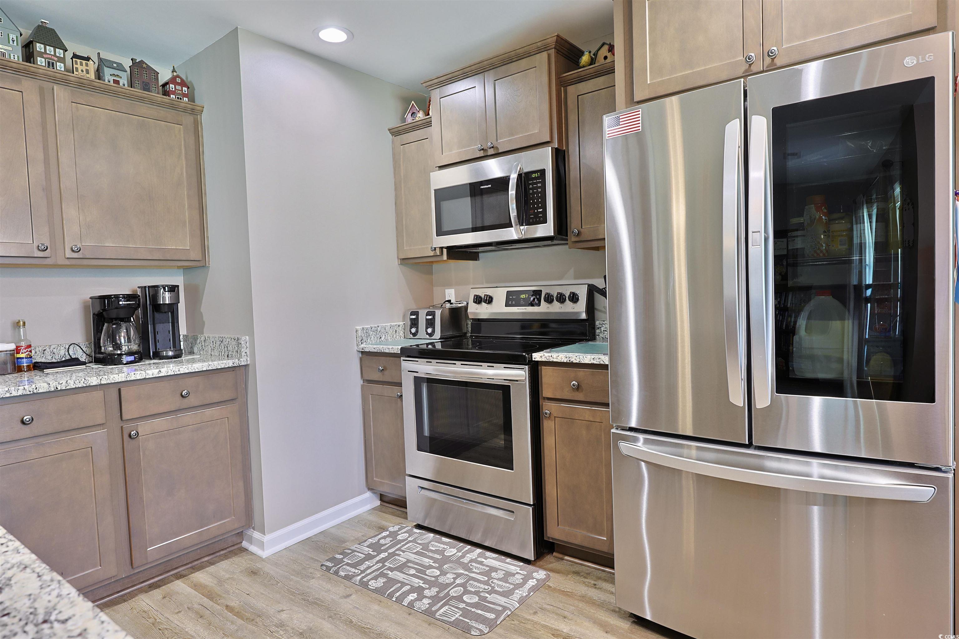 3604 Church Street Loris, SC 29569 - Photo 5 of 34 Kitchen with appliances with stainless steel finishes, light wood-type flooring, light stone counters, and recessed lighting