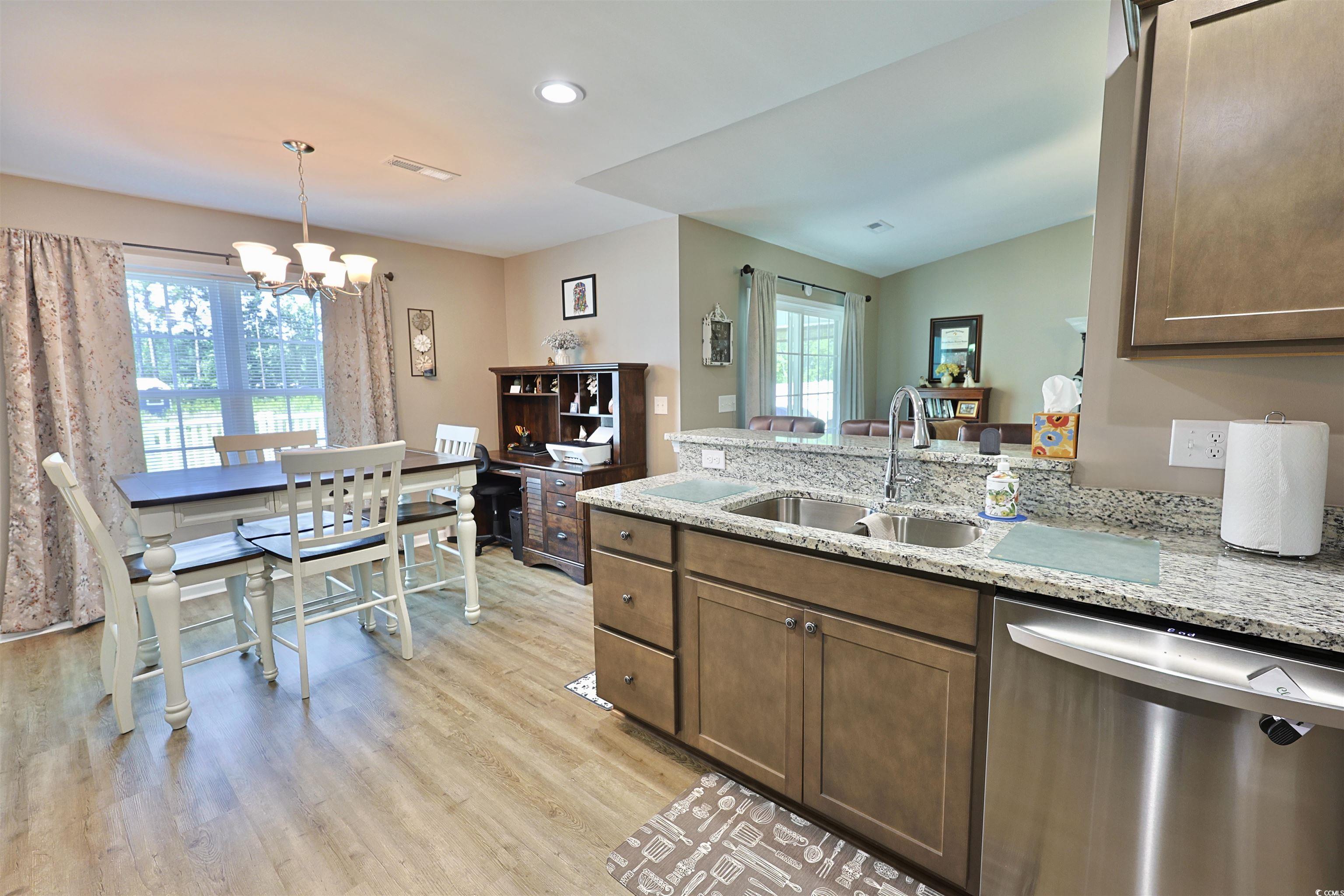 3604 Church Street Loris, SC 29569 - Photo 6 of 34 Kitchen featuring stainless steel dishwasher, a peninsula, plenty of natural light, a chandelier, and recessed lighting