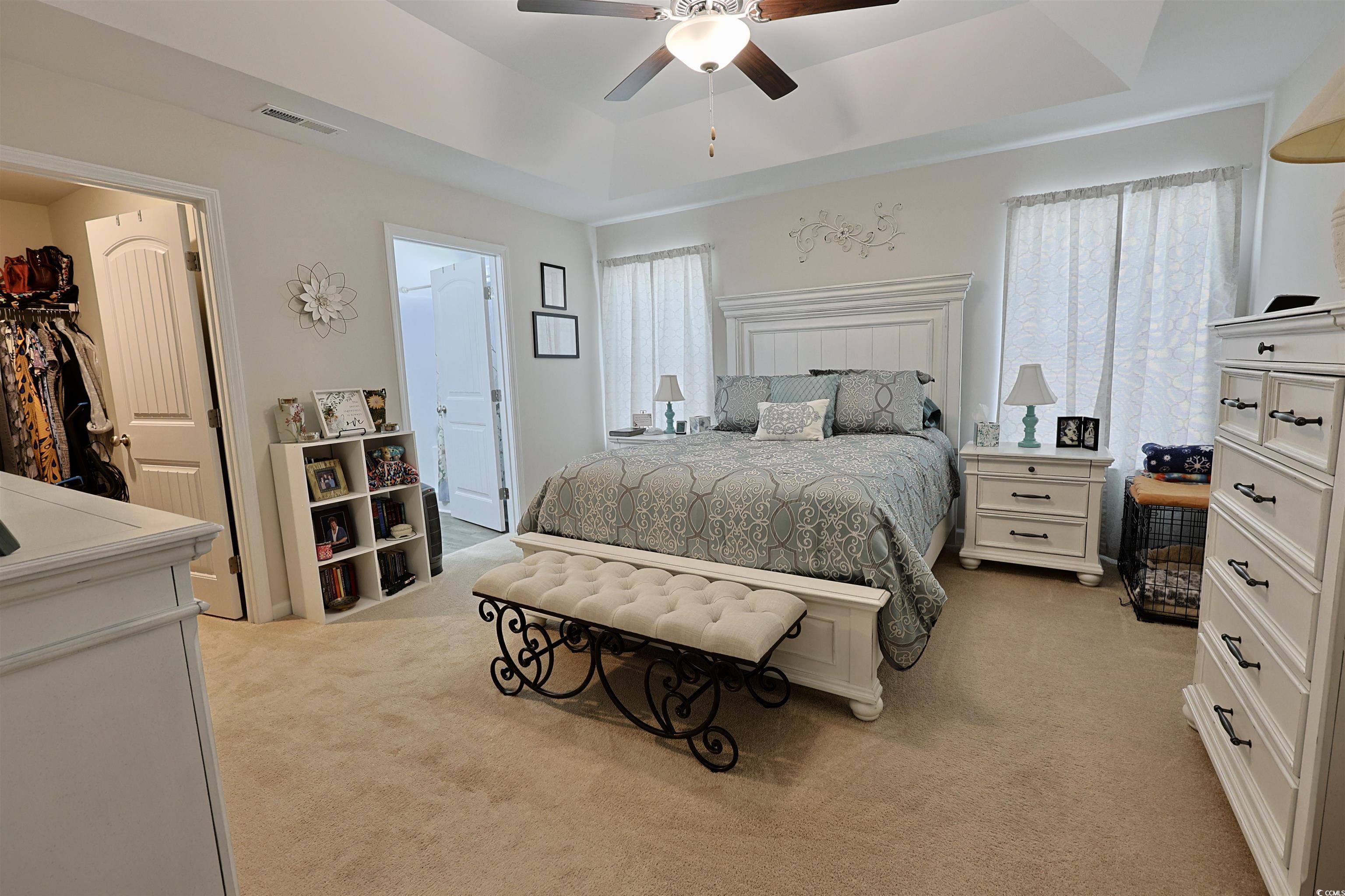 3604 Church Street Loris, SC 29569 - Photo 9 of 34 Bedroom with light colored carpet, a raised ceiling, ceiling fan, and ensuite bath