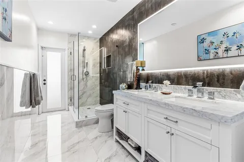 a view of backyard with swimming pool and palm tree