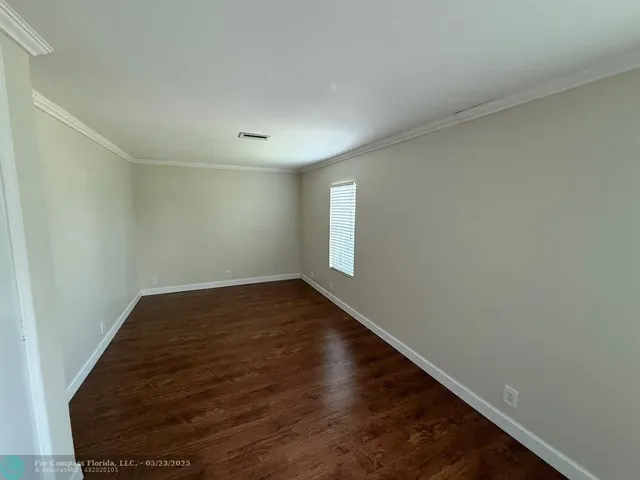 a view of a room with wooden floor